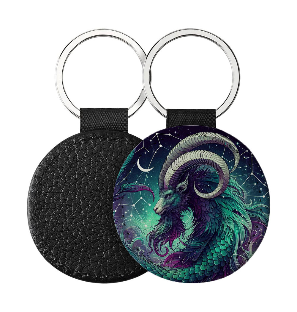 Portachiavi Rotondo CP-0014 in pelle PU con grafica astrologica del segno del Capricorno galattico nei toni dello smeraldo e viola, retro nero in pelle e anello in acciaio